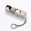 A set of cat-shaped keycaps fidget toys mounted on a clear plastic block with a silver lanyard.