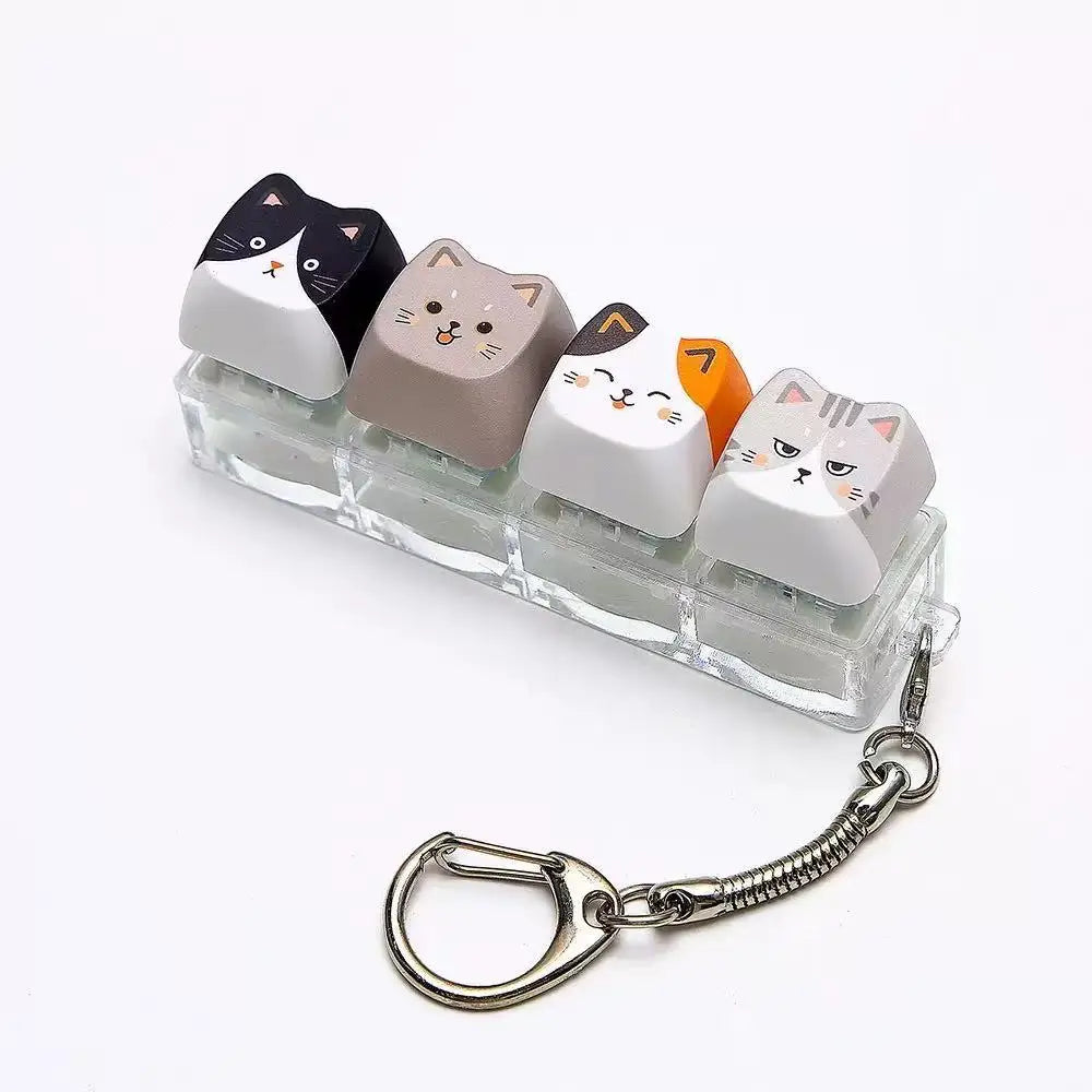 A set of cat-shaped keycaps used as a fidget toy attached to a silver metal lanyard.