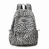 A leopard print laptop backpack with padded straps.