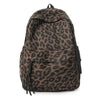 A brown leopard print canvas backpack shown from the back.