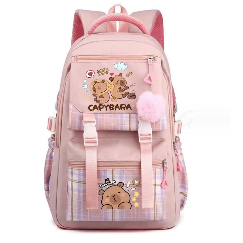 A pink canvas backpack featuring a cute capybara print and plaid accents.