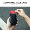 A hand holds a black carbon fiber RFID pop-up card holder displaying several cards.
