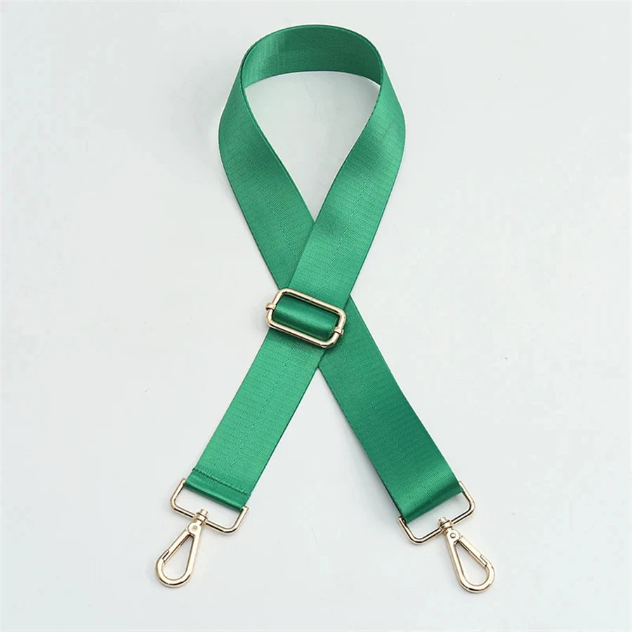 A green nylon adjustable shoulder strap with metal clasps, shown in an 'X' shape.