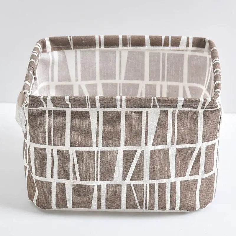A rectangular storage basket made of brown and white striped fabric for desk organization.
