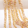 A close-up of strands of yellow-gold faceted crystal glass beads for jewelry making