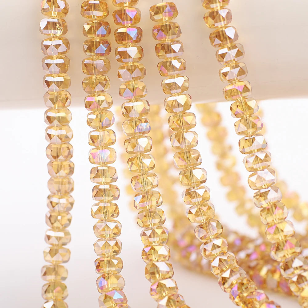 A close-up of strands of yellow-gold faceted crystal glass beads for jewelry making