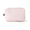 A pink and white striped seersucker cosmetic bag with a zipper closure.