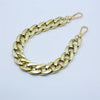 A gold-colored curb chain bracelet with a clasp, displayed on a white background.