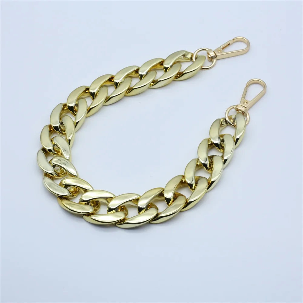 A gold-colored curb chain bracelet with a clasp, displayed on a white background.