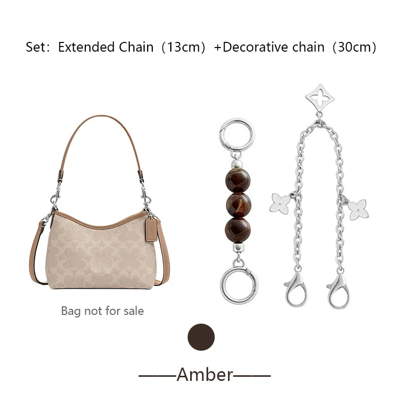 A beige faux leather bag with an extended chain and a decorative chain set for accessories