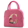 A pink insulated canvas lunch bag featuring a large gold letter G print.