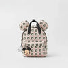 A pink and white cow print fashion backpack featuring Mickey Mouse ears.