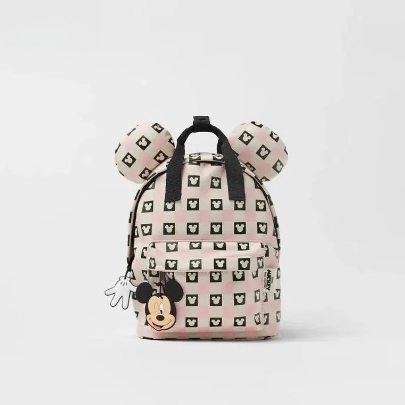 A pink and white cow print fashion backpack featuring Mickey Mouse ears.