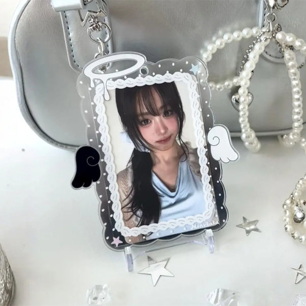 A clear acrylic photo card holder featuring a portrait of a girl with angel wings and pearl chains.