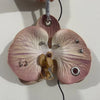 A realistic orchid flower keychain with pink and purple markings hanging from a silver ring.