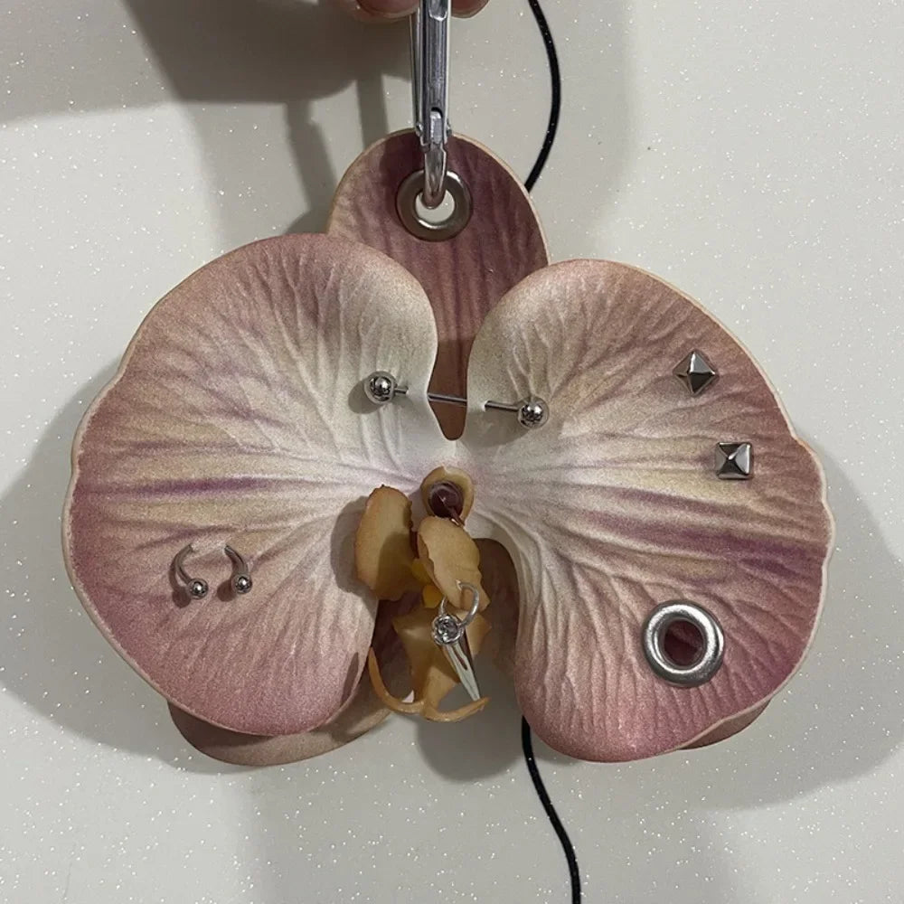 A realistic orchid flower keychain with pink and purple markings hanging from a silver ring.