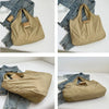 A beige foldable mini keychain tote bag shown in various angles against a denim background.