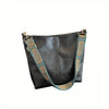 A black leather geometric strap crossbody hobo bag with blue and gold patterned straps.