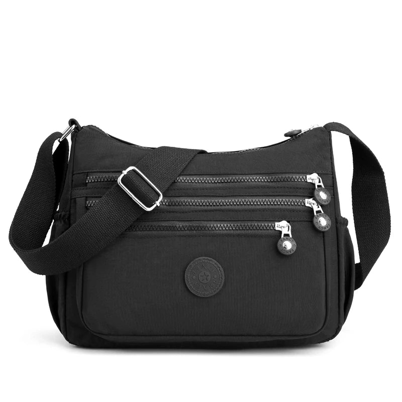 Black waterproof nylon crossbody shoulder bag with zippered pockets and adjustable strap