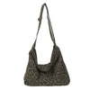 A dark brown leopard print canvas shoulder bag with an adjustable strap.