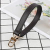 A black genuine leather replacement shoulder strap with a gold-toned metal clasp is displayed on a white background.