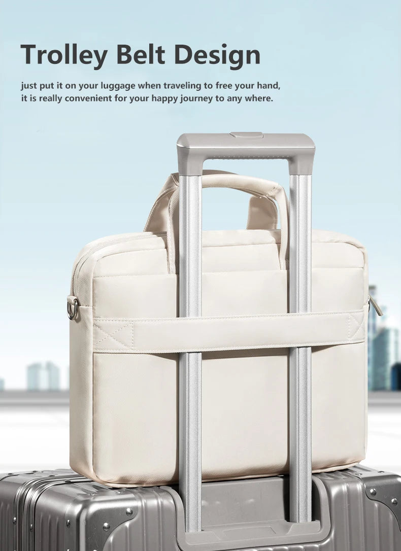A beige trolley belt design laptop bag is shown resting on a gray suitcase.