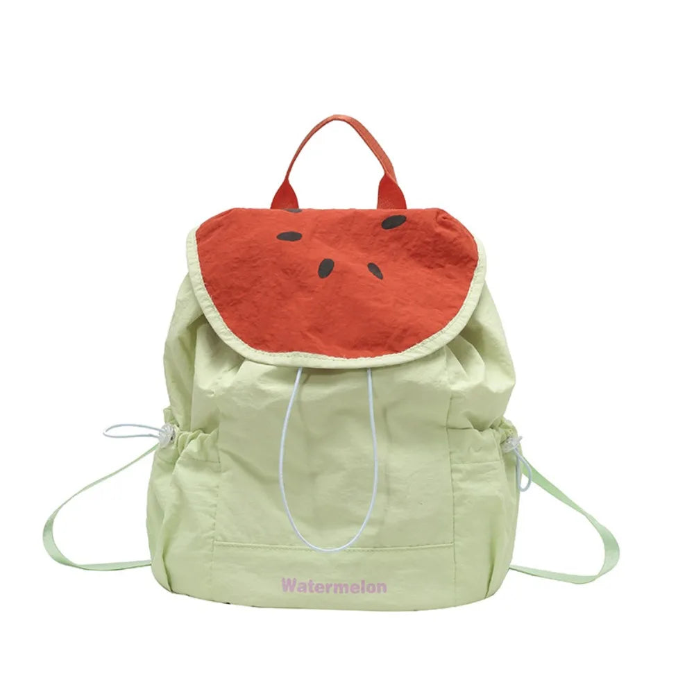 A light green nylon messenger backpack with an orange watermelon-shaped fabric flap and white drawstrings.