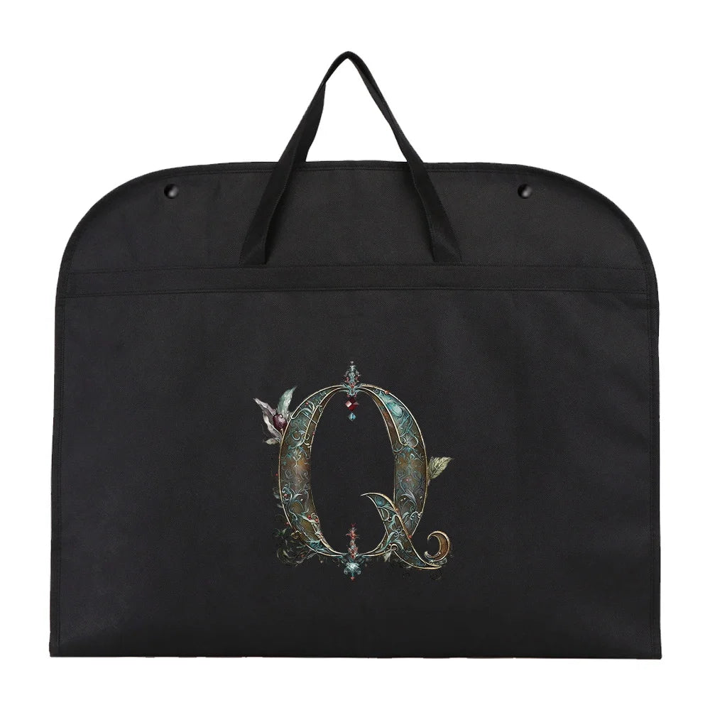 Black fabric dust cover and storage bag with a decorative ornate letter Q embroidered on it.