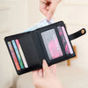 A hand is showing a black minimalist RFID blocking wallet with several cards and an ID inside.