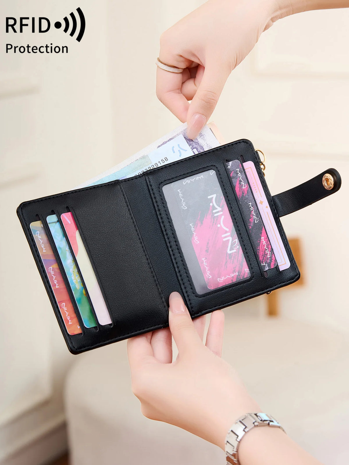 A hand is showing a black minimalist RFID blocking wallet with several cards and an ID inside.