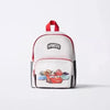 White backpack with a red strap and a graphic featuring a cow print design.