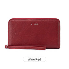 A maroon leather wallet with a zipper closure and the brand name MIYIN visible on the surface.