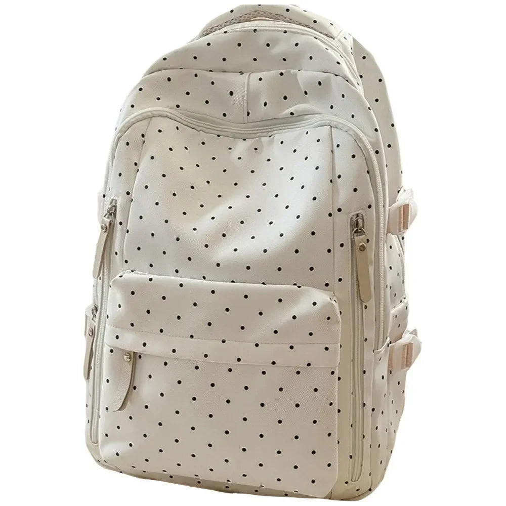 A cream-colored corduroy backpack with a black polka dot pattern.