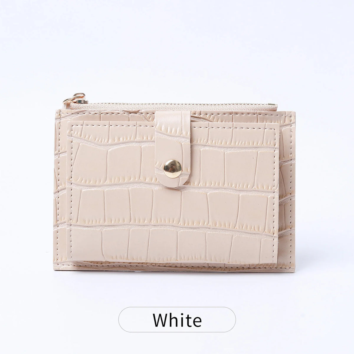A light beige mini card holder made of crocodile pattern leather with a zipper closure.