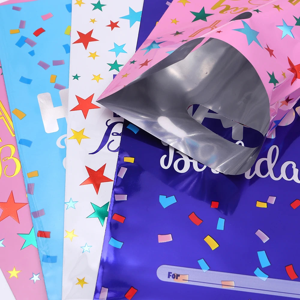 A close-up of colorful, shiny birthday party gift bags in pink, blue, and purple packaging.