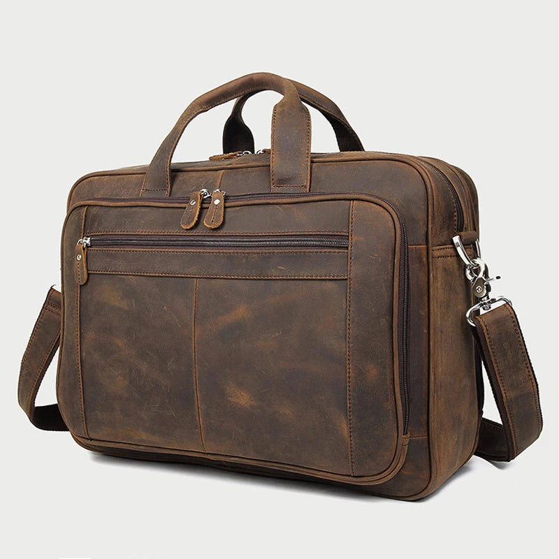 A brown genuine leather briefcase with a top handle and flap, shown from the front.
