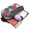 A men's PU leather shoulder bag with a wide strap featuring a patchwork design and holding a smartphone and notebook.