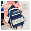 A navy blue backpack featuring a lucky bunny design and light beige accents, worn by a person.