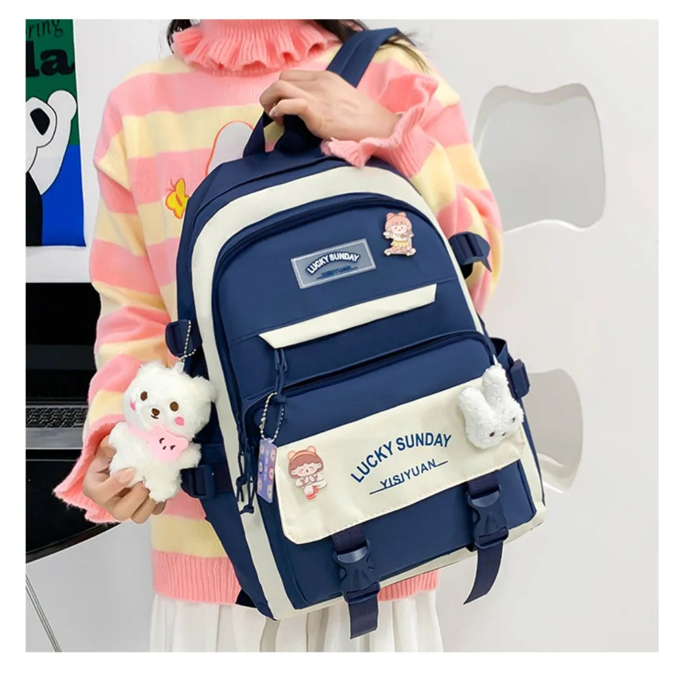 A navy blue backpack featuring a lucky bunny design and light beige accents, worn by a person.