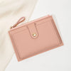 A light pink ultra-thin PU leather card holder wallet with a stitched flap and leather pull tab.