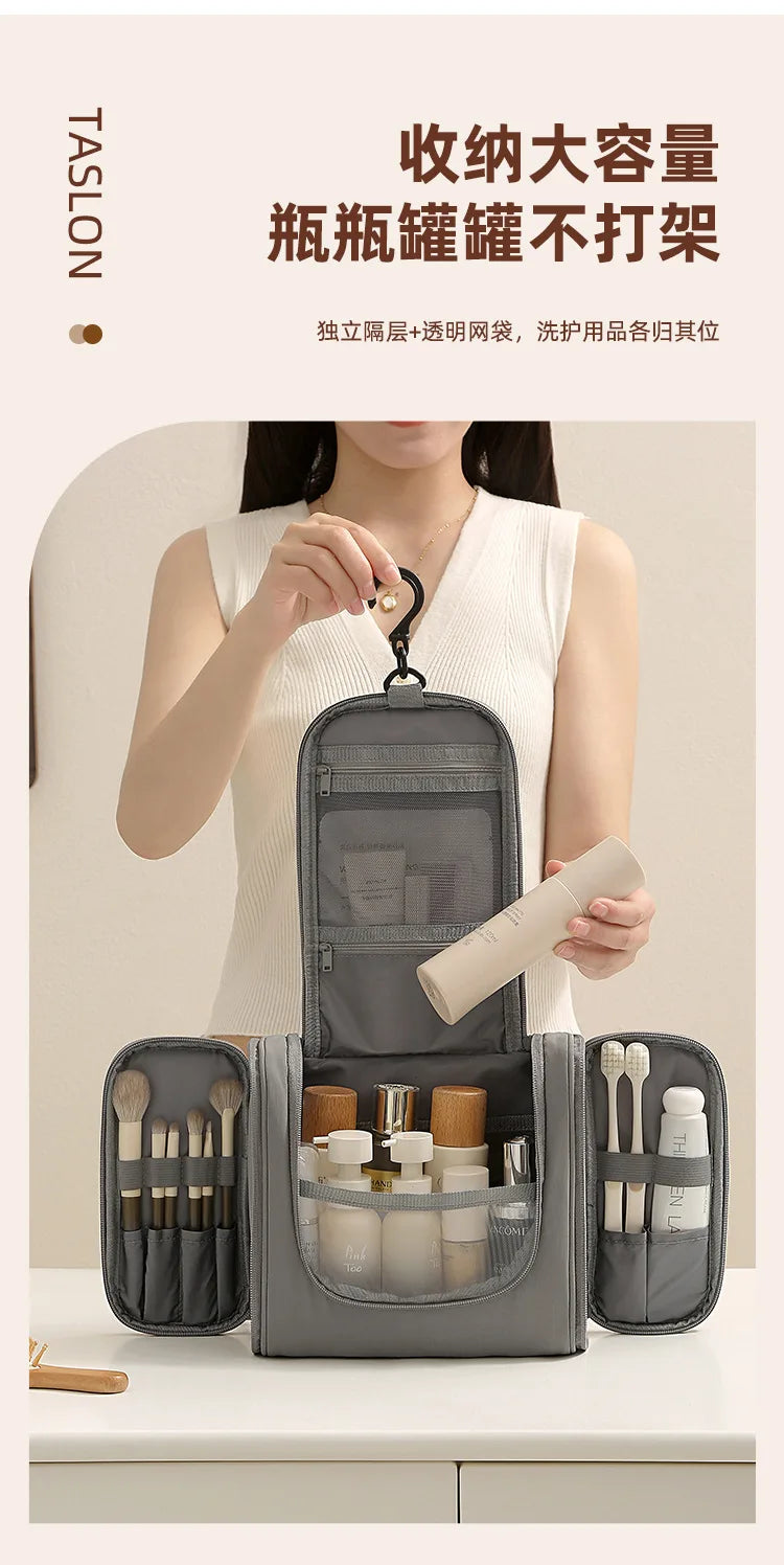 A person holds a gray waterproof hanging toiletry bag with various grooming tools inside, displayed on a white surface.