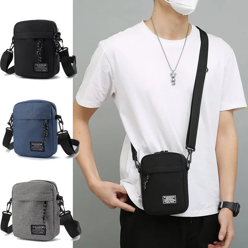 A man wears a white t-shirt and carries a black compact crossbody sling bag on his chest.