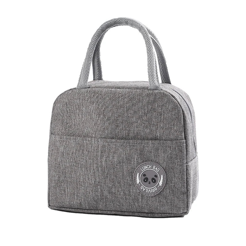 A gray insulated lunch bag with a woven strap and a circular logo on the front.