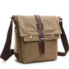A tan canvas messenger bag for men with brown leather straps and buckles.