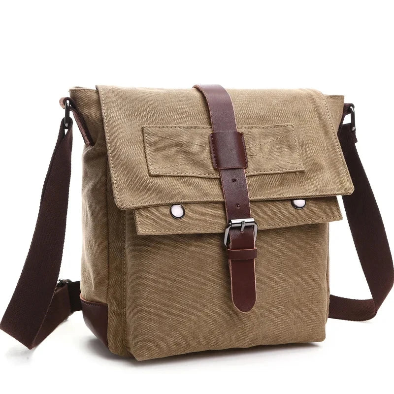 A tan canvas messenger bag for men with brown leather straps and buckles.