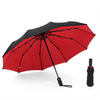 A red and black heavy-duty windproof automatic umbrella open against a white background.
