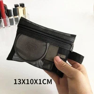 A hand holds a black mesh cosmetic storage pouch with a zipper, showing its size.