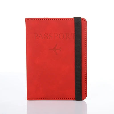 A red leather passport organizer with black stitching and a flap closure.