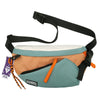 A beige nylon chest rig bag with a light blue accent and black strap is shown.