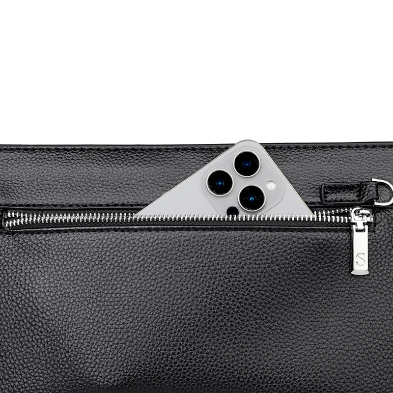A close-up of a black PU leather clutch bag with a silver zipper and a triangular camera lens design detail.